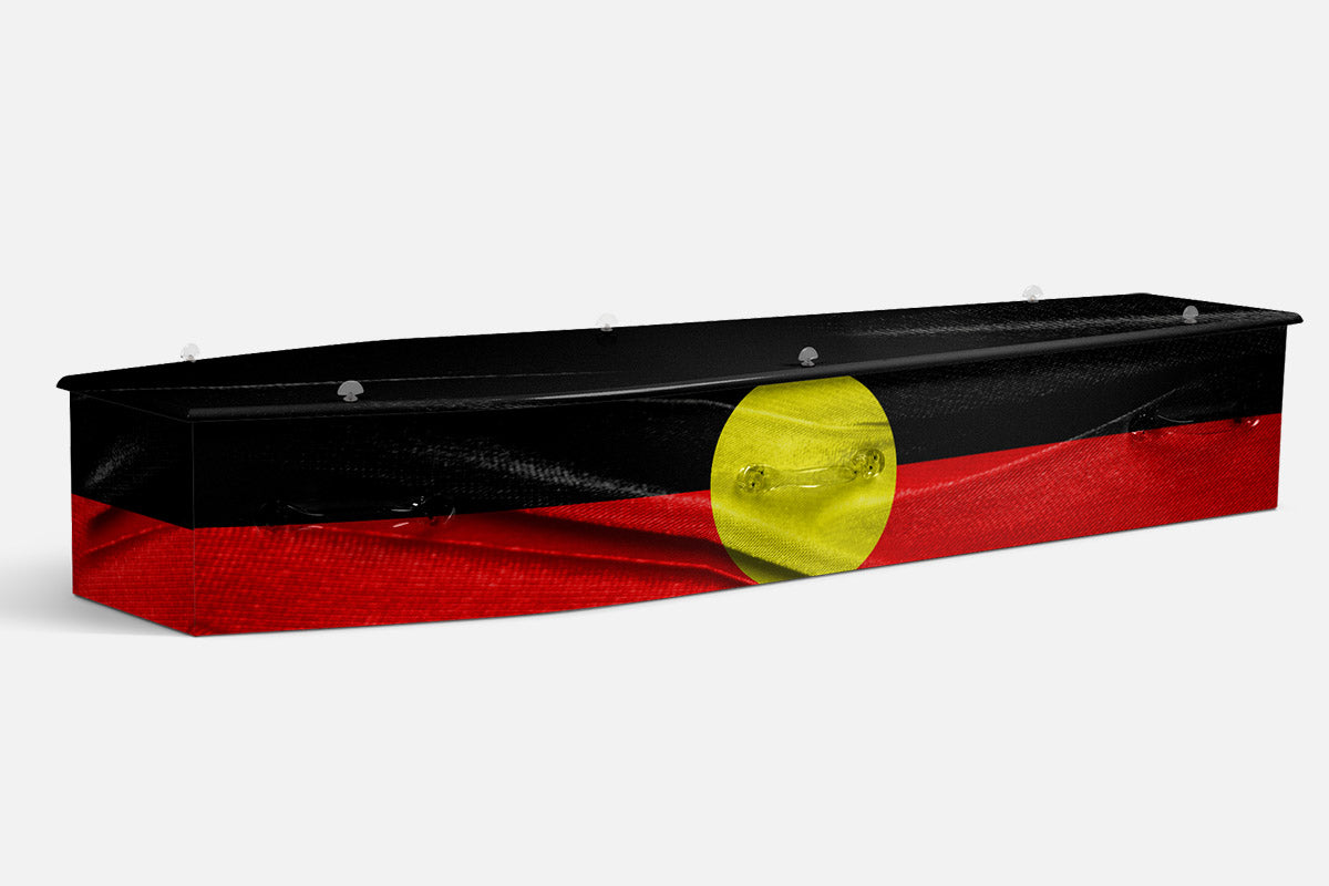 Aboriginal Flag coffin in black, red and yellow with a central yellow circle on draped fabric