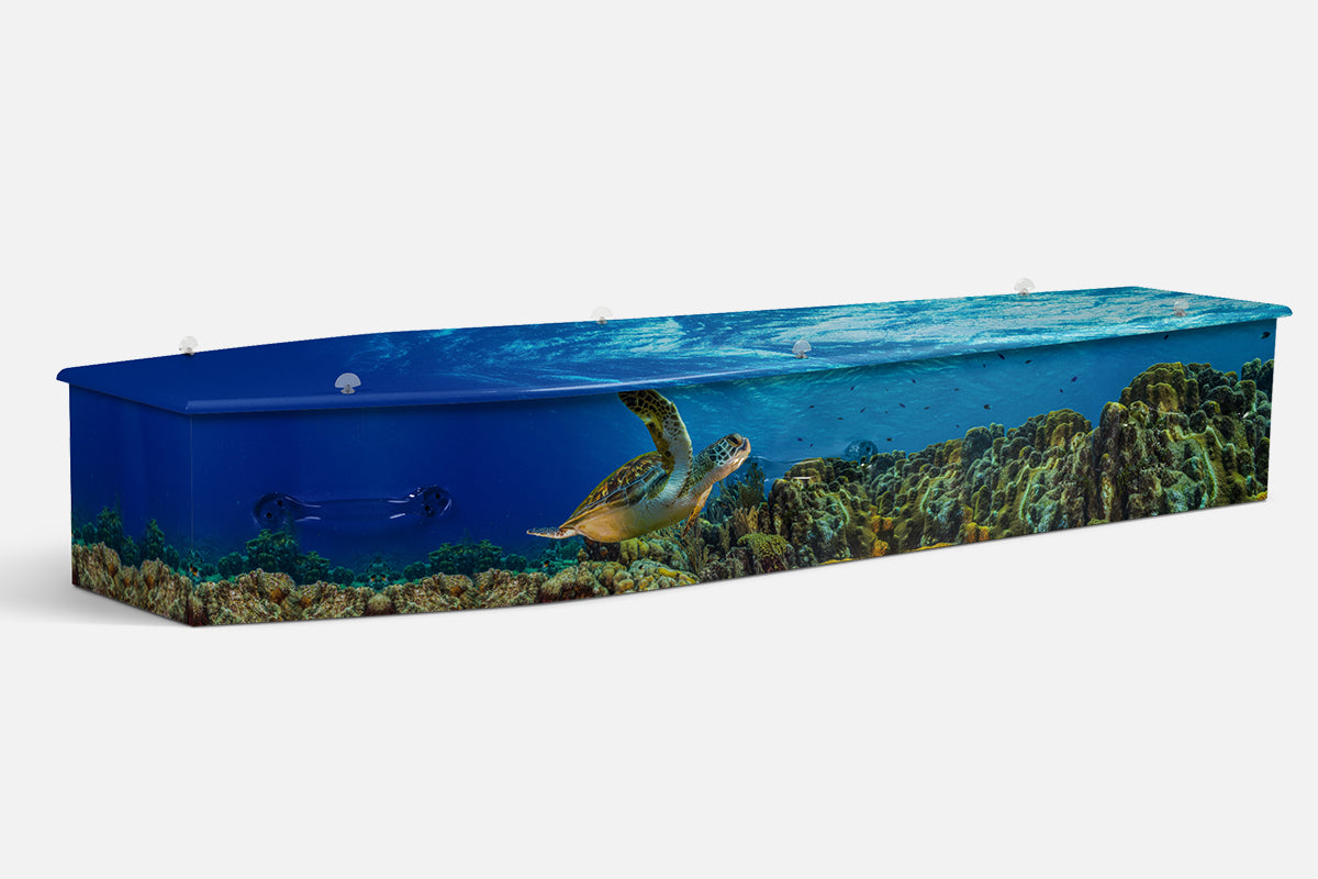 Aquatic Kingdom coffin in blue with a photographic sea turtle swimming over a coral reef
