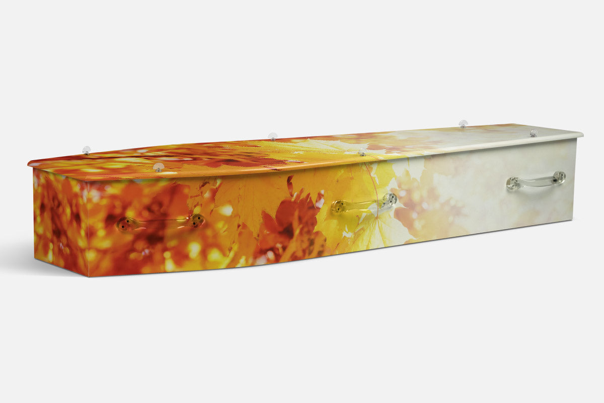 Autumn Leaves coffin in orange, red and yellow foliage fading into soft cream light