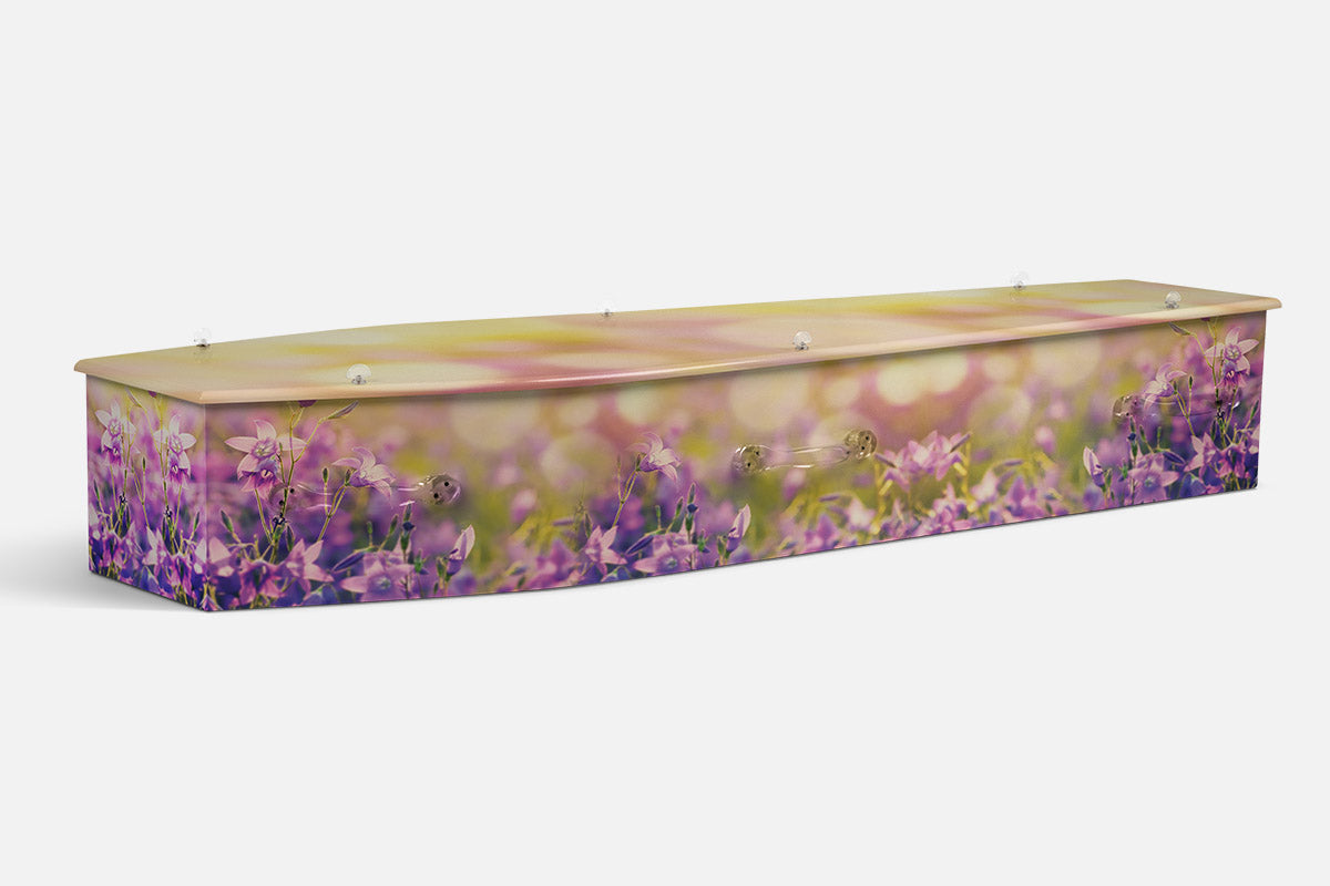 Azure Harmony coffin in a purple wildflower meadow under soft golden light