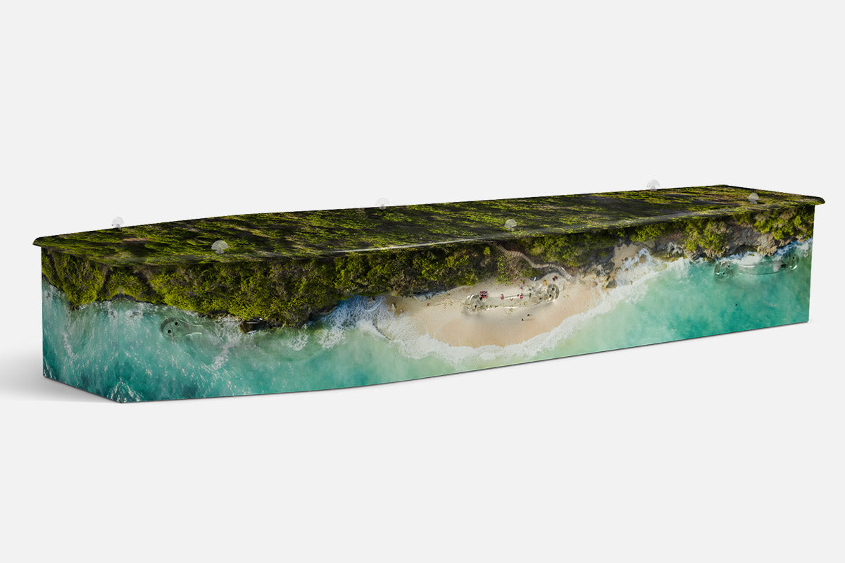 Bali coffin in an aerial rainforest cliff over a turquoise cove and beach