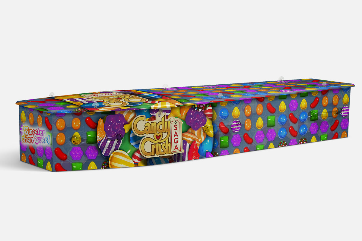 Candy Crush coffin in a colourful pattern of game candies with the gold Candy Crush Saga logo