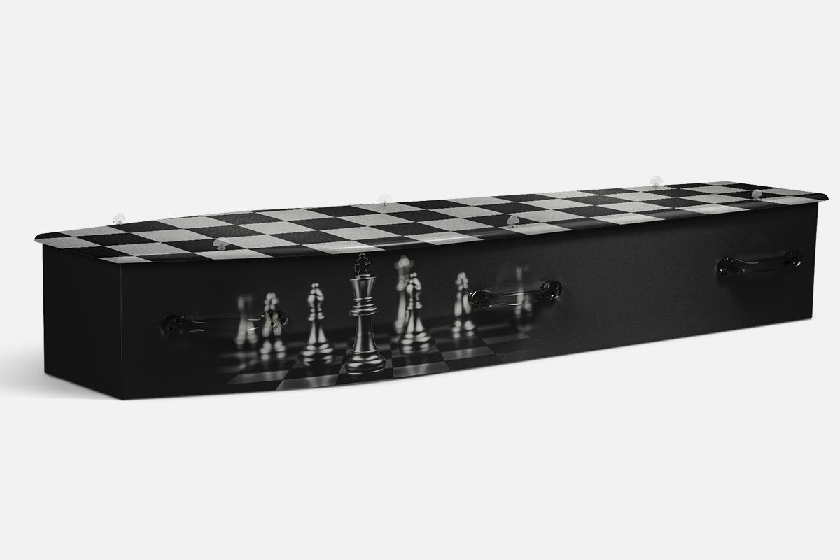 Chess coffin in black with a checkerboard lid and a black and white chess set on the side