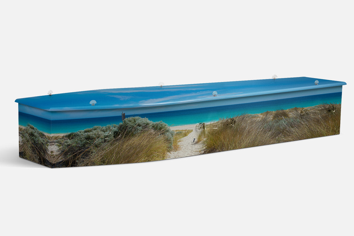 Coastal Delight coffin in a photographic scene of a sandy dune path leading to a blue ocean