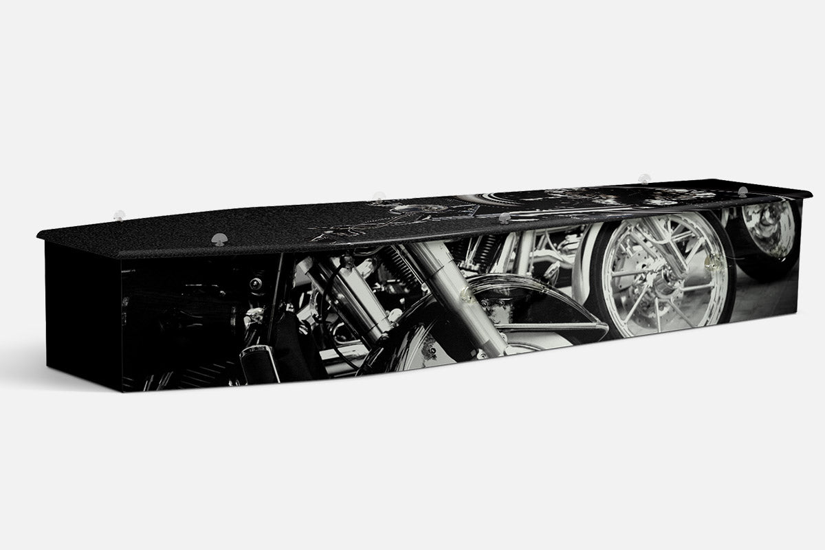 Motorbikes coffin in black and white with a close up of motorcycle wheels and forks