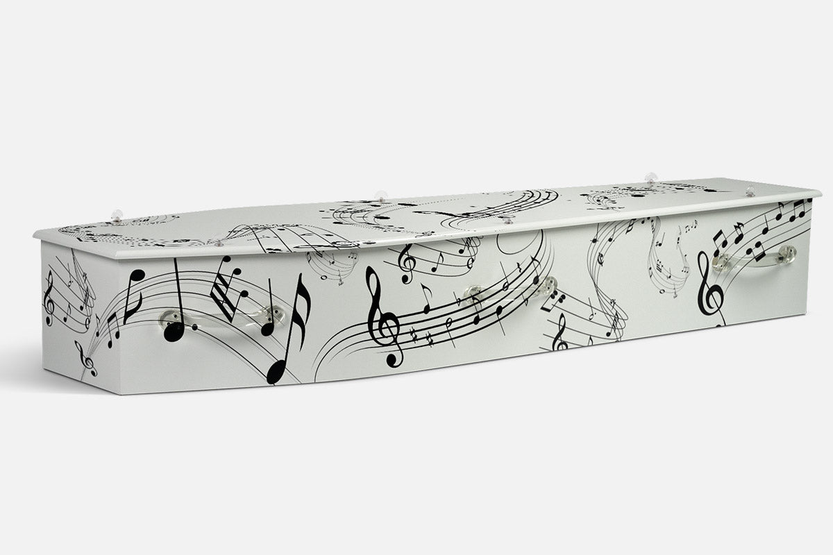 Music coffin in white with flowing black music staves, notes and treble clefs across the surface