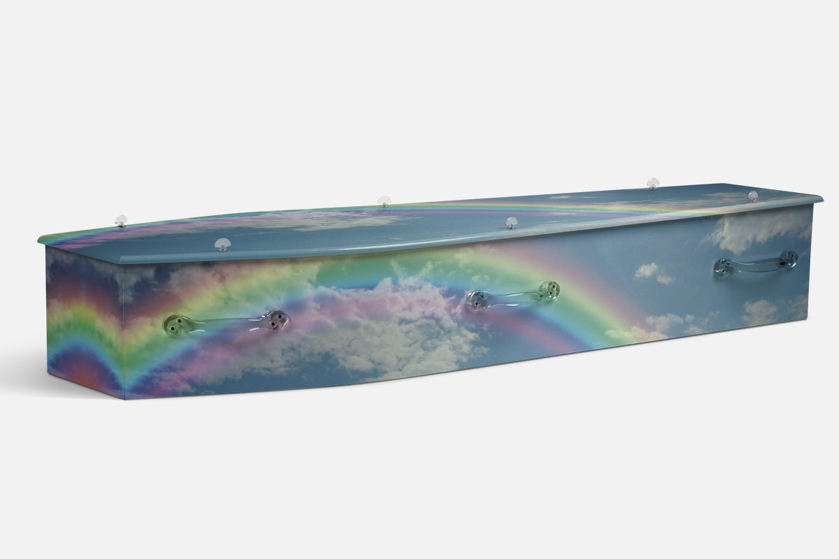 Nature Rainbow Rhythms coffin in a rainbow arching over clouds against a blue sky, photographic