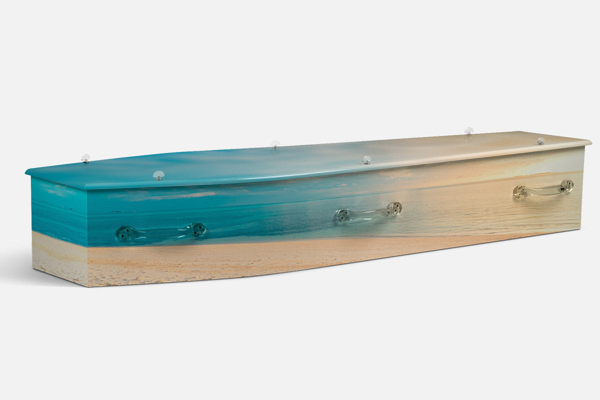 Sandy Serenity coffin in a turquoise ocean fading into pale sand, photographic beach design