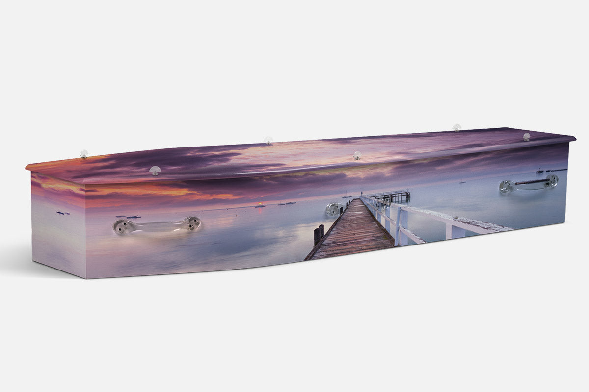 Sorento Dawn coffin in a photographic scene of a wooden jetty stretching into calm water at sunrise