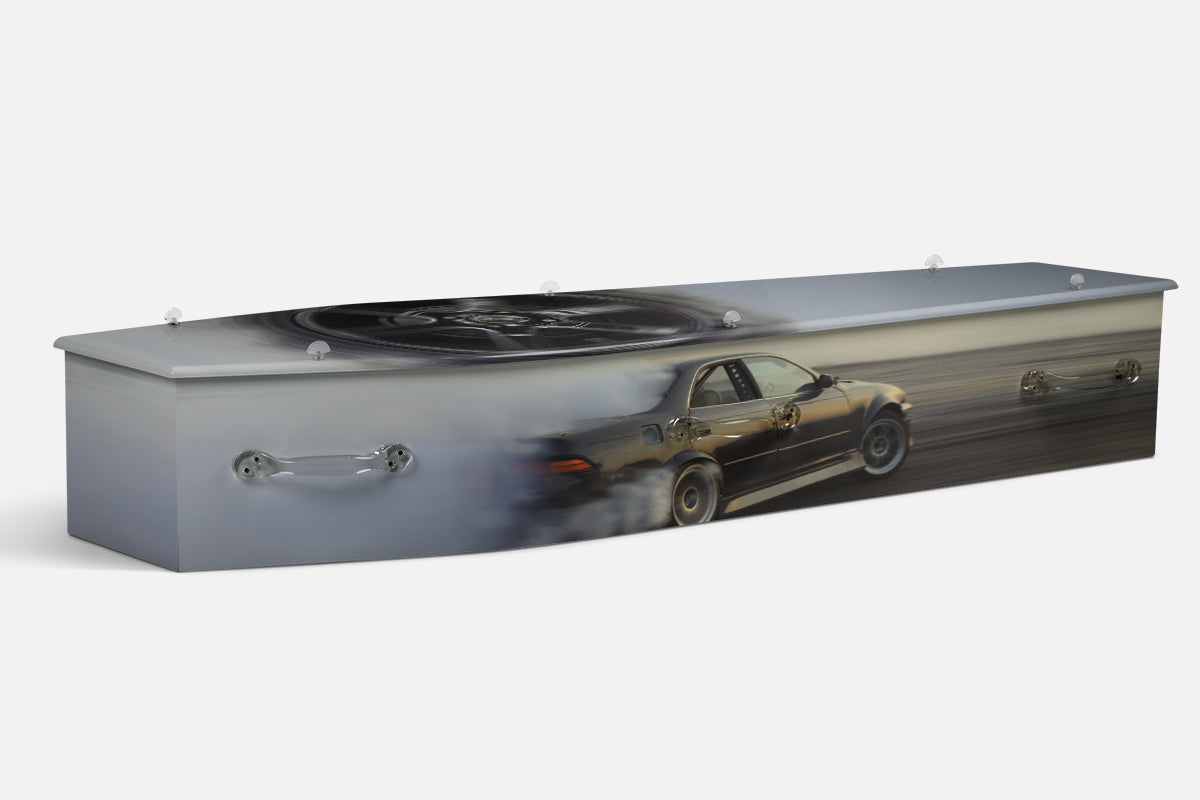 Sport Drifting coffin in grey with a dark car drifting sideways and a chrome wheel close up