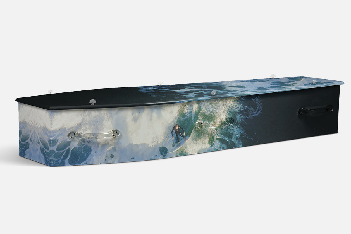 Surfing coffin with an aerial photograph of a surfer riding a breaking blue wave