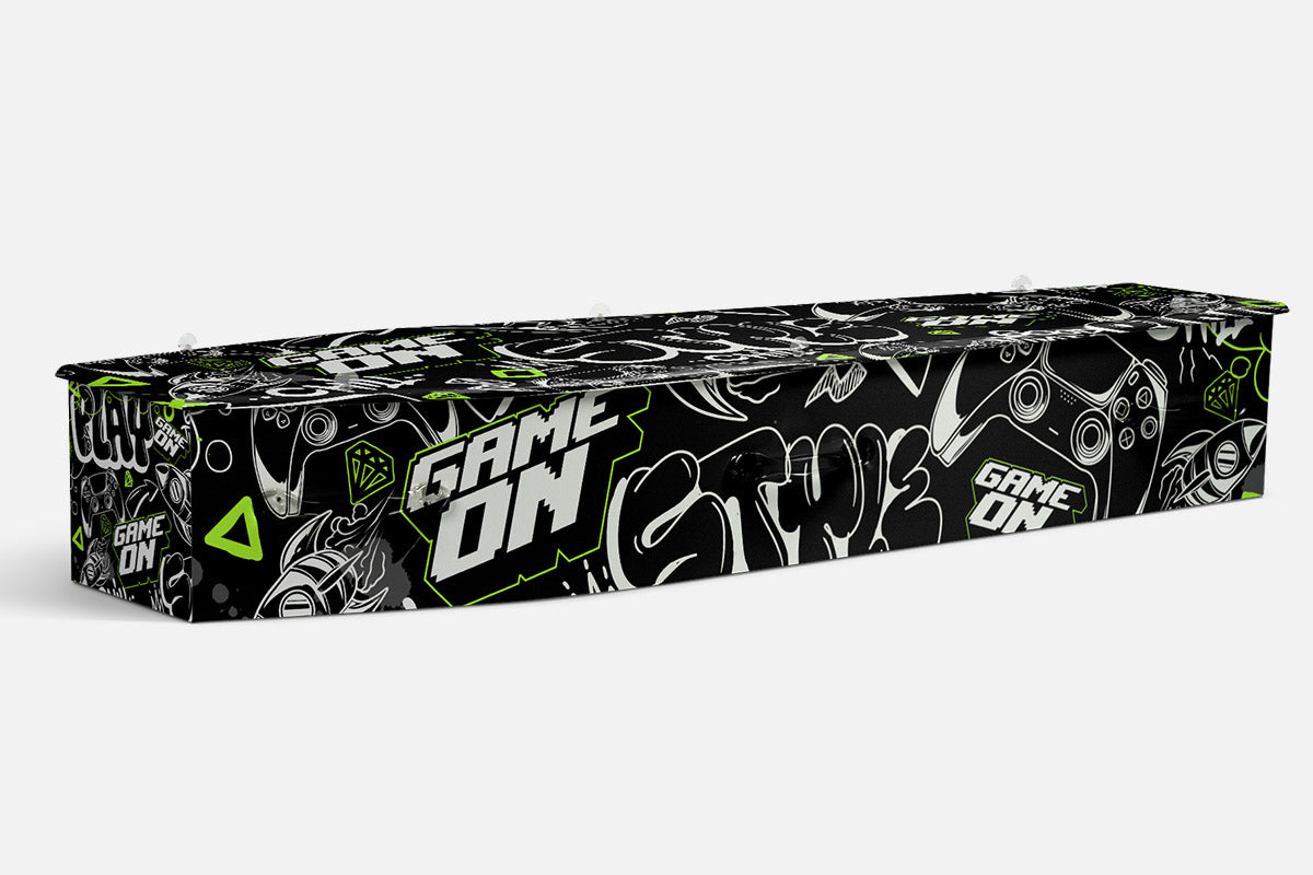 The Gamer coffin in black with neon green Game On lettering, game controllers and graffiti style icons
