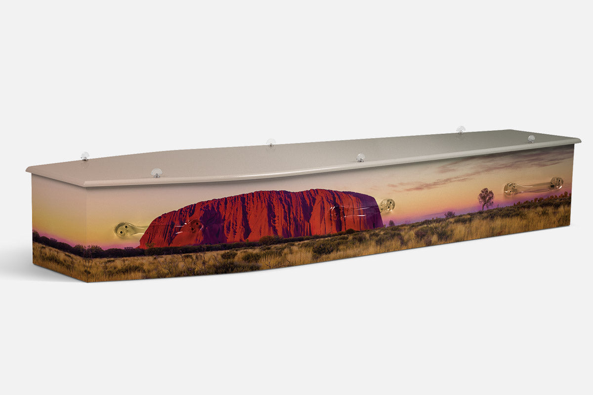 Uluru coffin in a photographic scene of the red rock monolith under a dusk sky