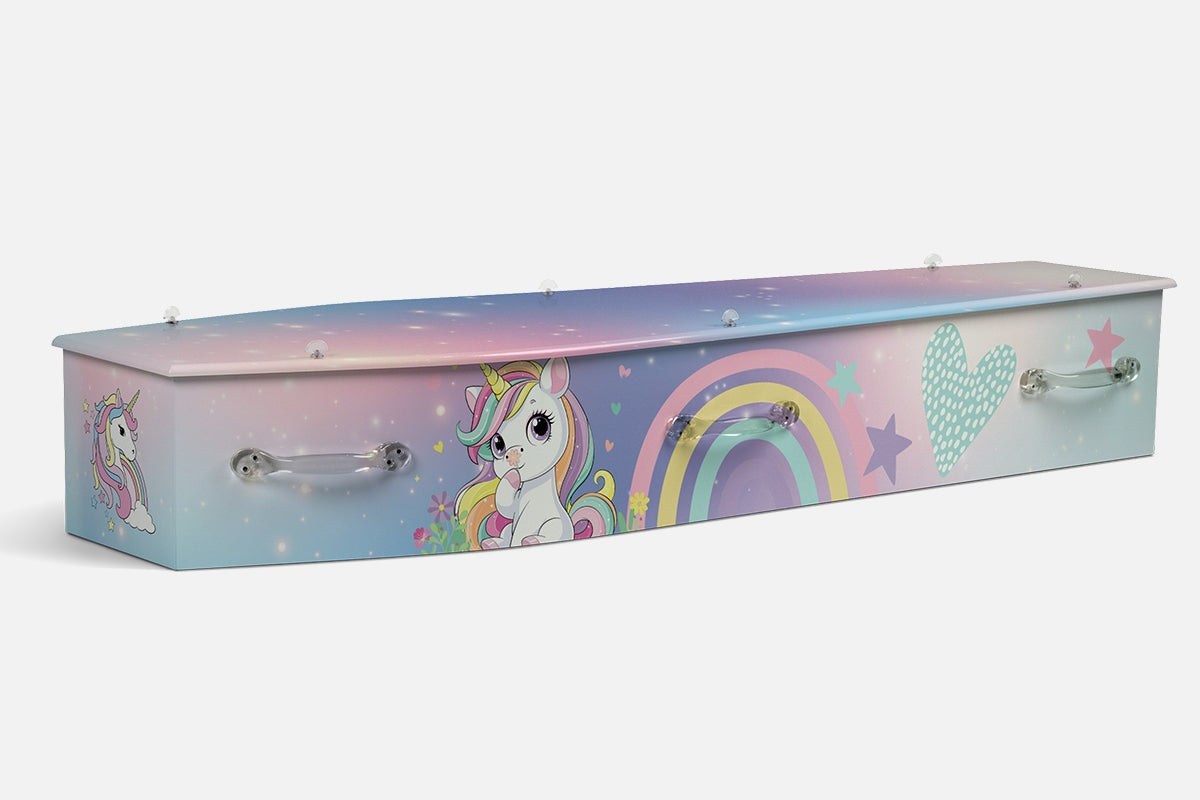 Unicorns coffin in pastel pink and blue with an illustrated unicorn, rainbow, stars and a heart