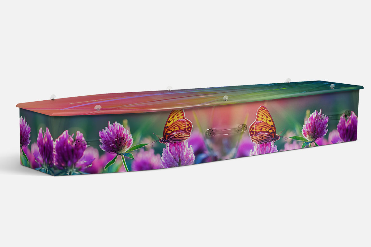 Wild Flowers coffin in purple clover blooms with orange butterflies, photographic garden design